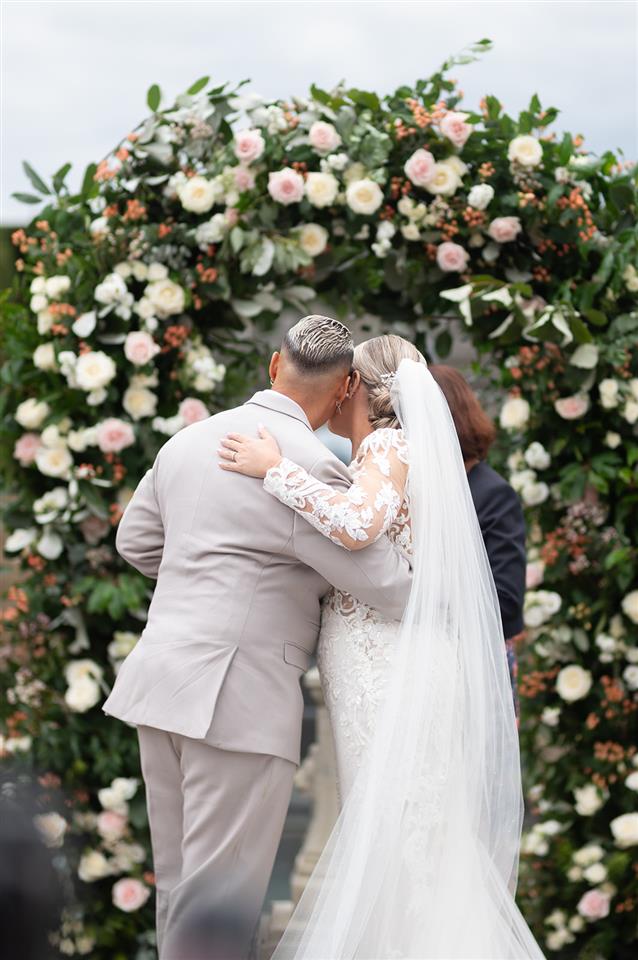 Bedfordshire same sex wedding at Shortmead house. Statement flower arch in blush colours with the brides standing in front of it